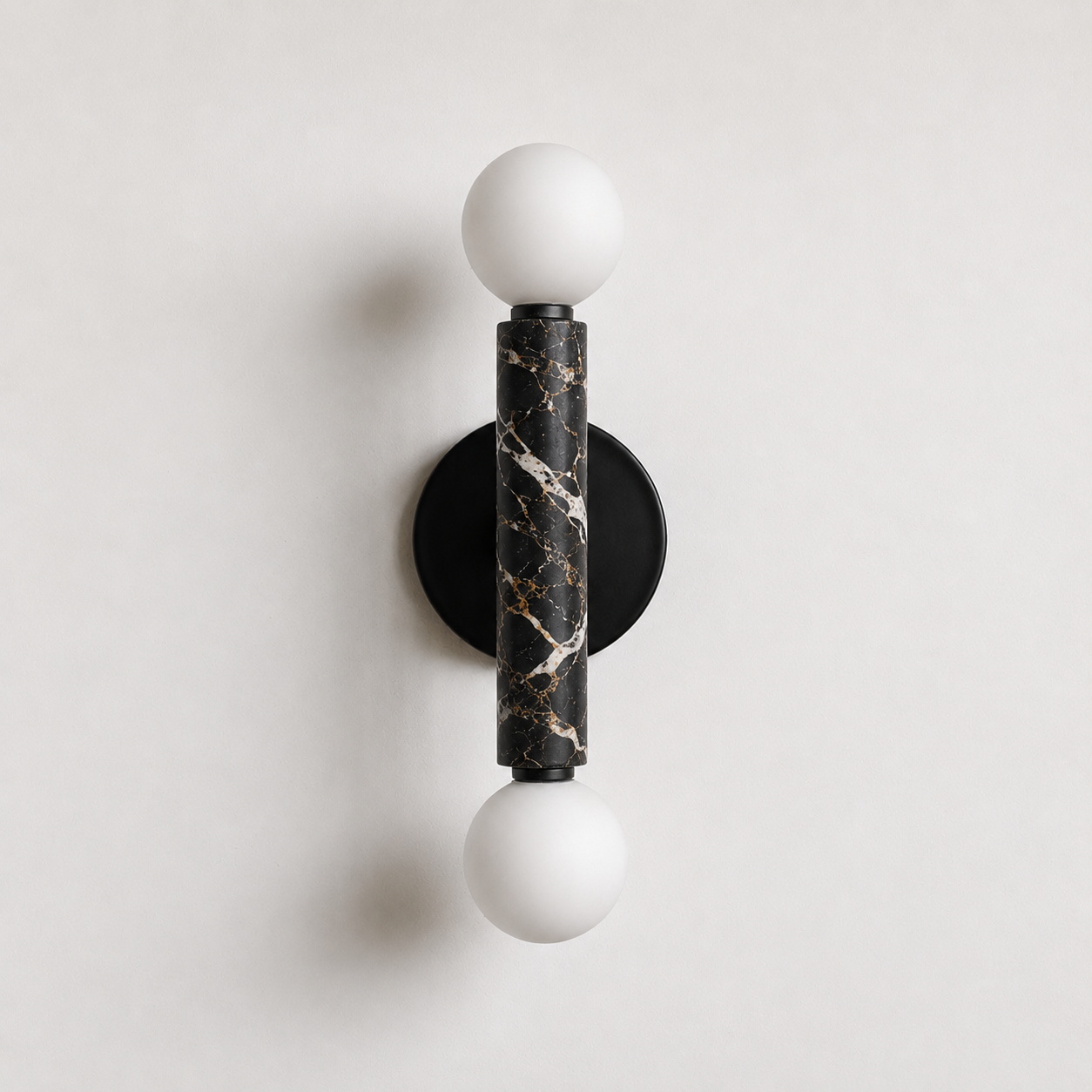 Baton Dual Globe Sconce - Nero Portoro, a black circular backplate, a central black marble cylinder with gold veining, and two matte white spherical shades on either end | IINK Interiors