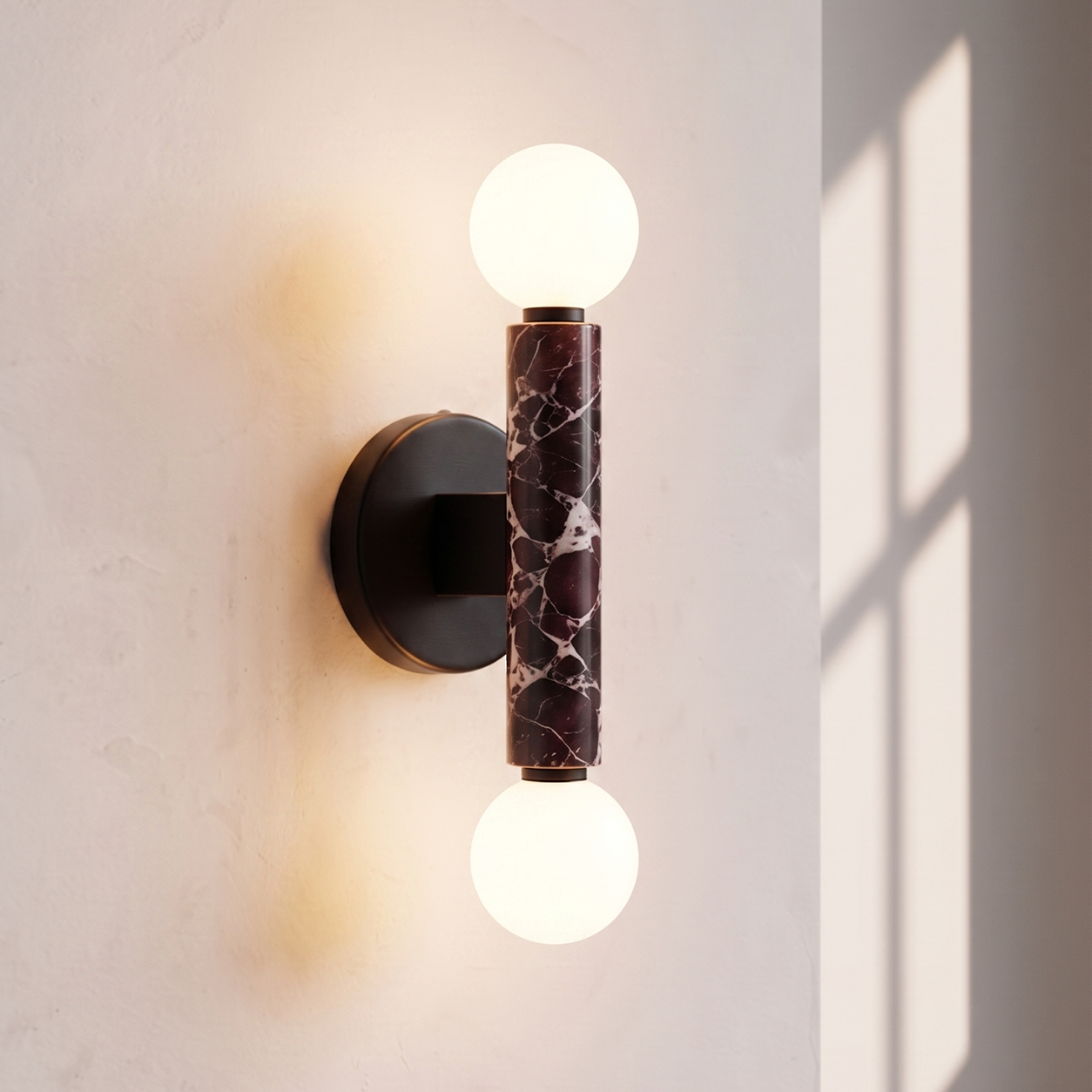 Baton Dual Globe Sconce - Rosso Levanto- two glowing white globe bulbs and a central dark marble column | IINK Interiors
