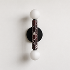 Baton Dual Globe Sconce - Rosso Levanto- two glowing white globe bulbs and a central dark marble column | IINK Interiors