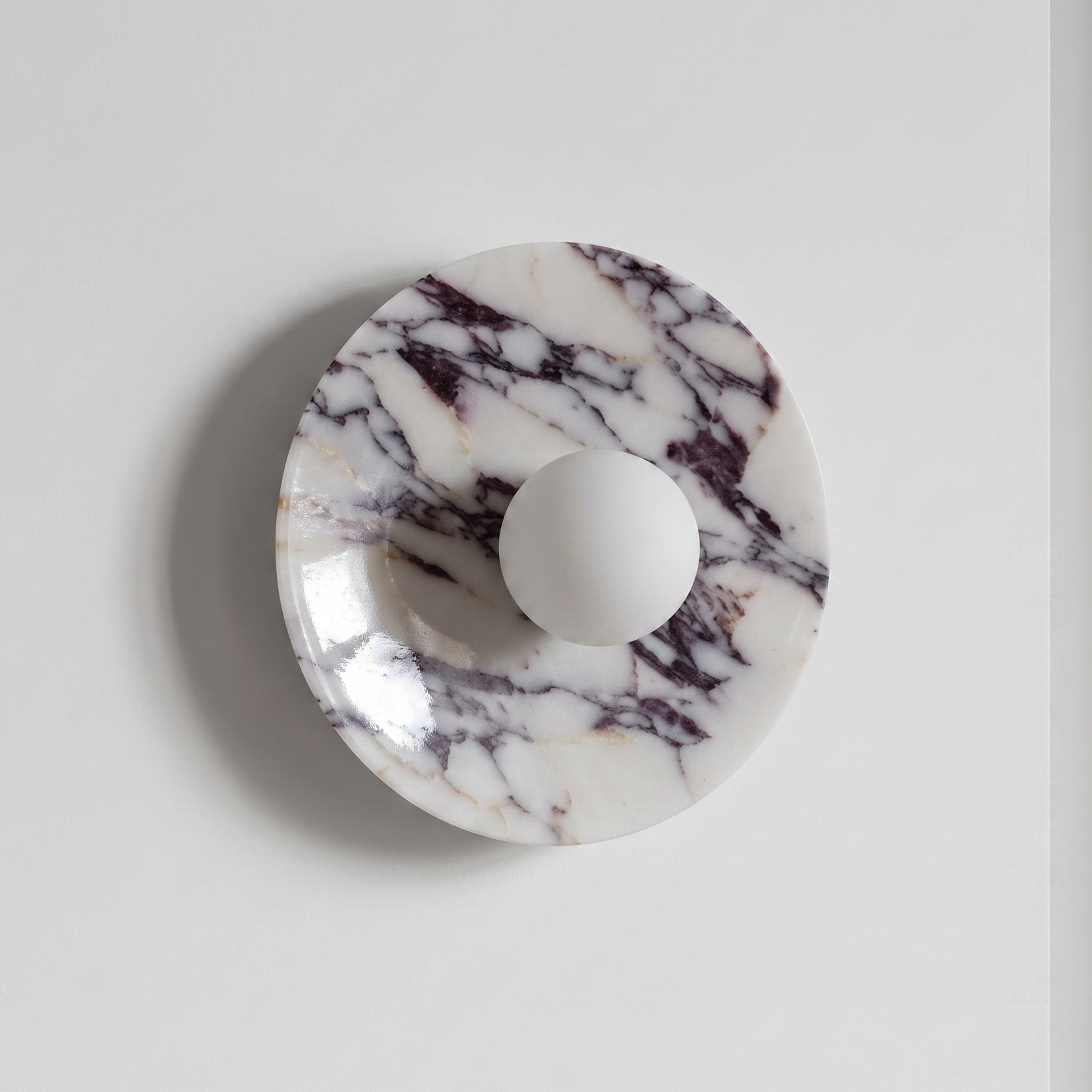 Tondo Planar Sconce - Calacatta Viola- A round marble cabinet knob with a white spherical center. | IINK Interiors