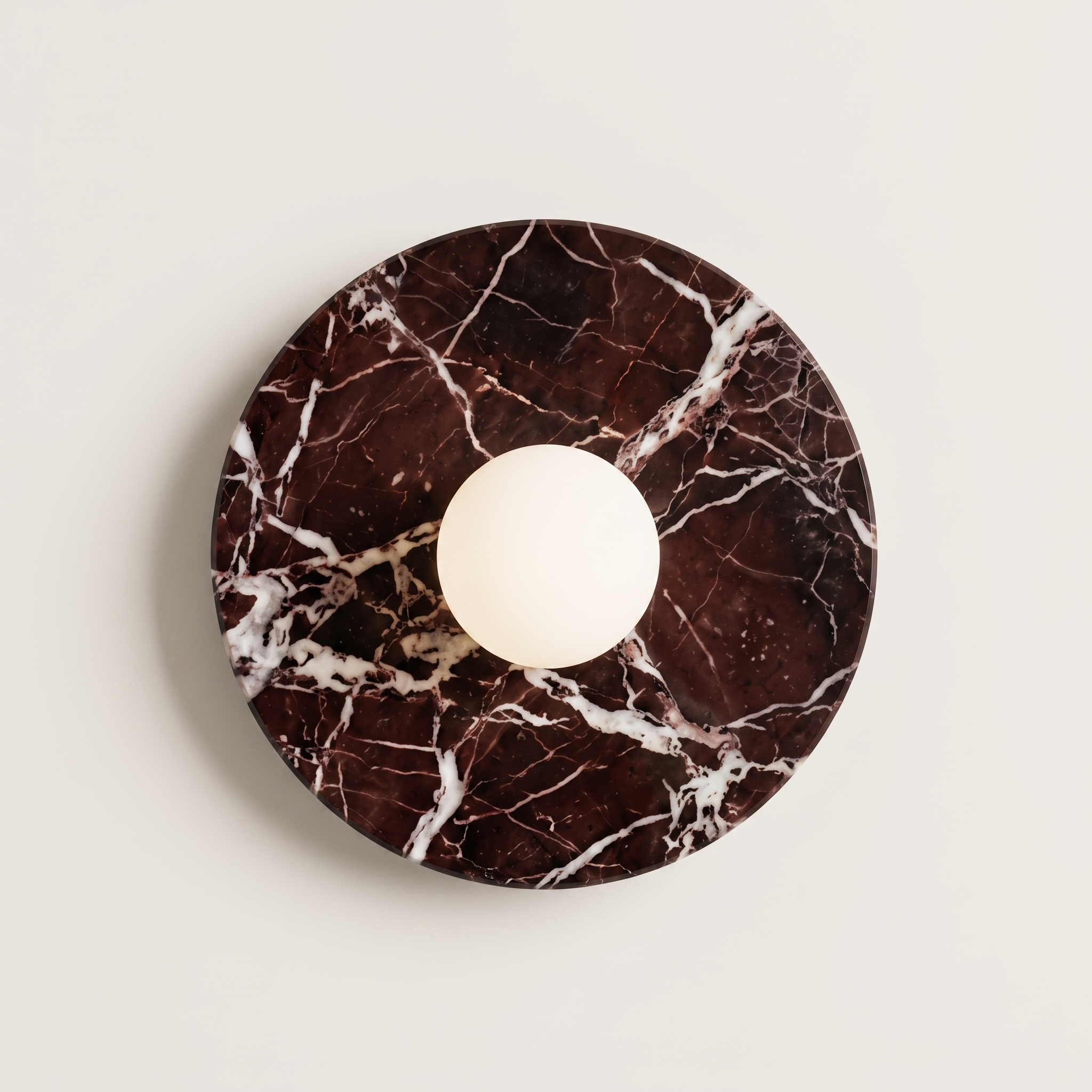 Tondo Planar Sconce - Rosso Levanto- around wall sconce featuring a dark brown and white marble base with a central white spherical light fixture.  | IINK Interiors