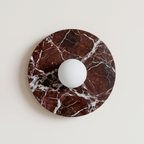 Tondo Planar Sconce - Rosso Levanto- around wall sconce featuring a dark brown and white marble base with a central white spherical light fixture.  | IINK Interiors