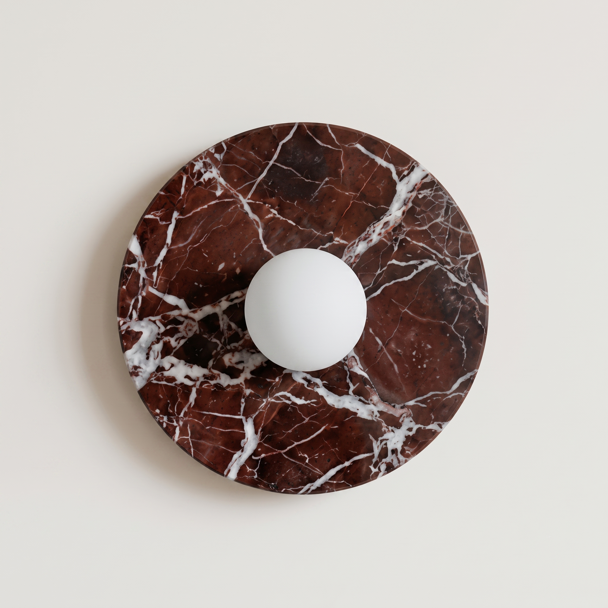 Tondo Planar Sconce - Rosso Levanto- around wall sconce featuring a dark brown and white marble base with a central white spherical light fixture.  | IINK Interiors