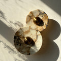 A wall sconce with two Calacatta Viola plates and a brass centre. IINK Interiors